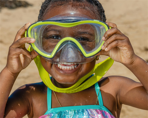 girl on the beach with goggles