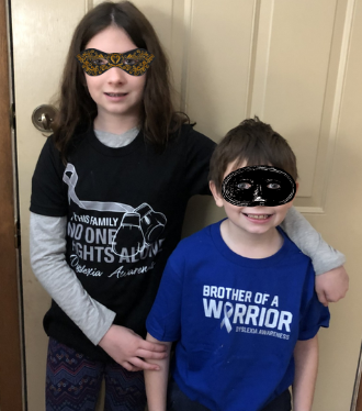 A brother and sister wear Dyslexia Awareness t-shirts