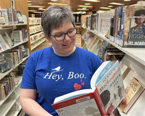 kara wearing hey boo shirt reading to kill a mockingbird