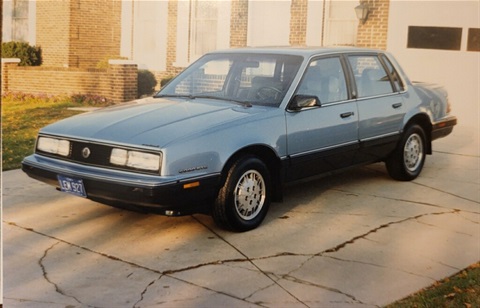 Vintage photo of a blue, 1980s model Chevrolet car.